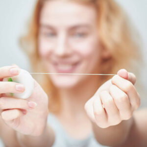 Lady holding floss out in front of her