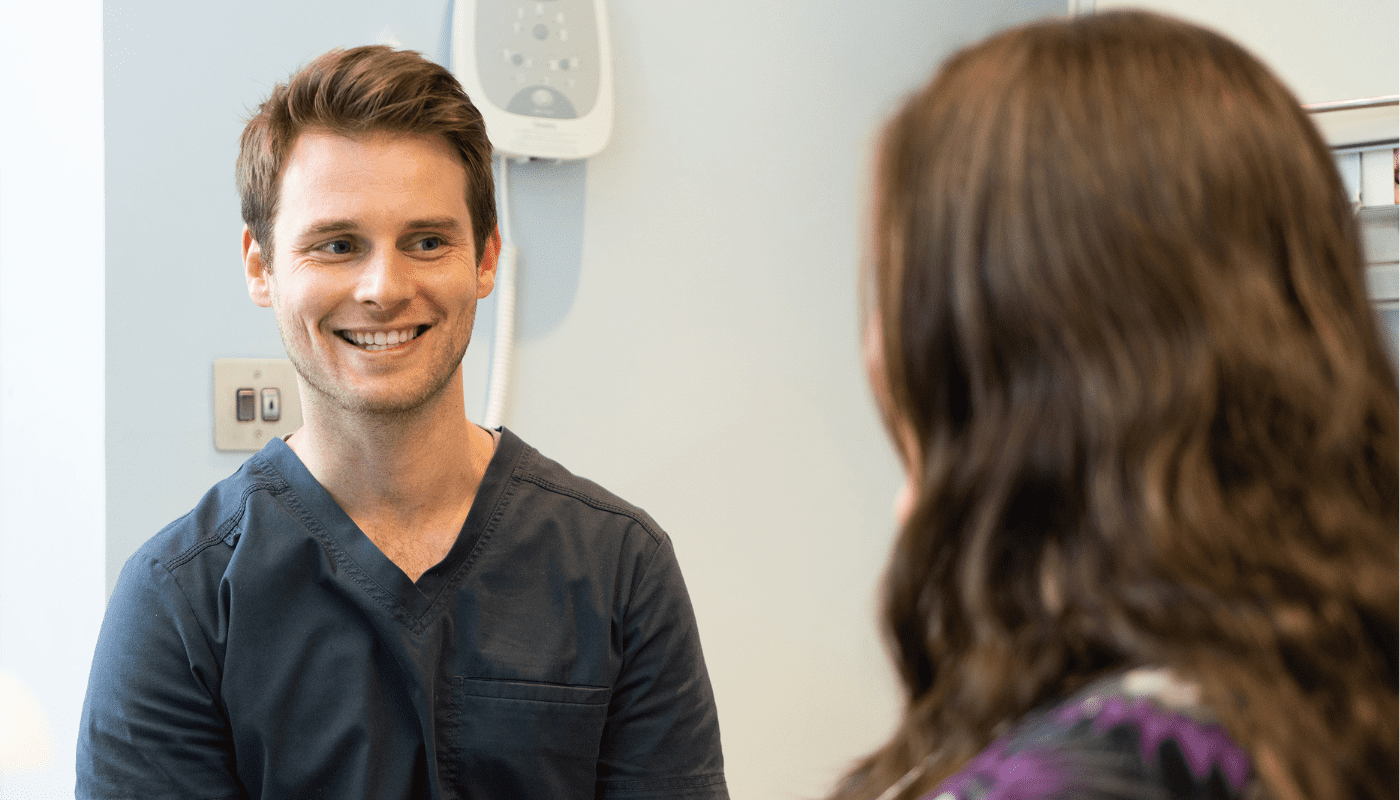 Dr Peter Bell smiling at patients in the dental surgery before starting the routine dental exam